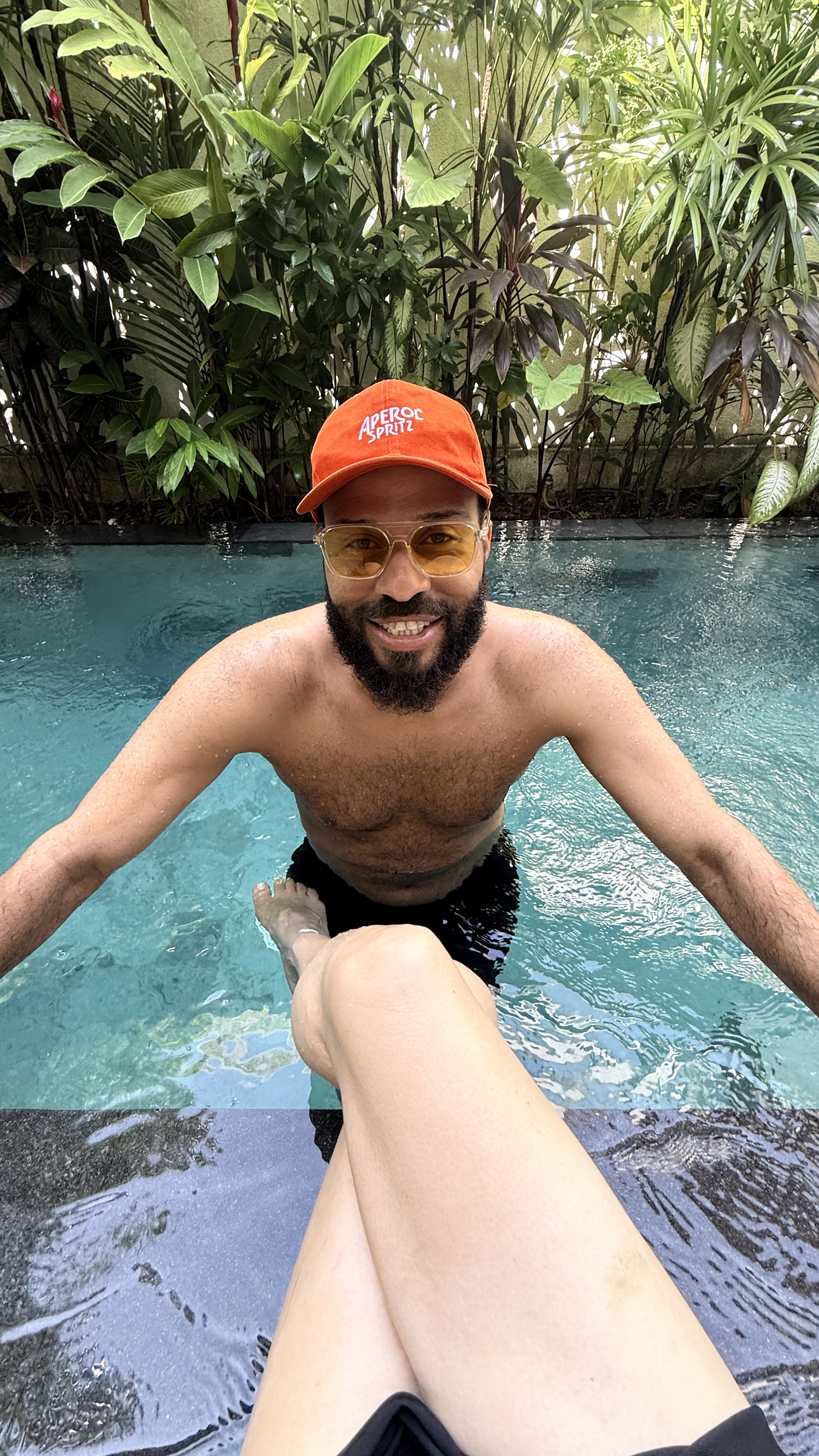 Taylor smiling at the camera from the pool.